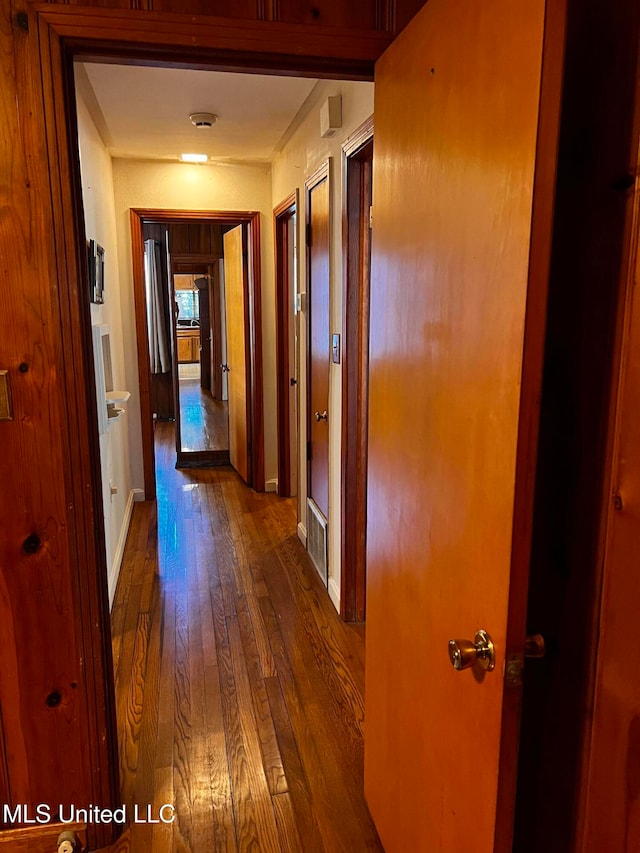 corridor featuring dark hardwood / wood-style floors