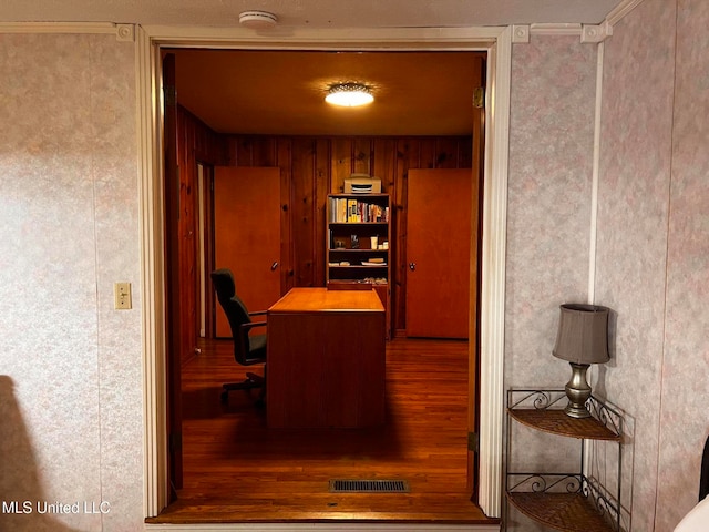 office space with hardwood / wood-style floors, wood walls, and ornamental molding