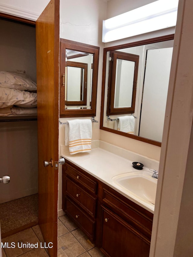 bathroom with tile patterned flooring and vanity