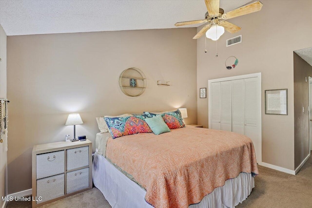 bedroom with visible vents, a closet, baseboards, high vaulted ceiling, and light colored carpet