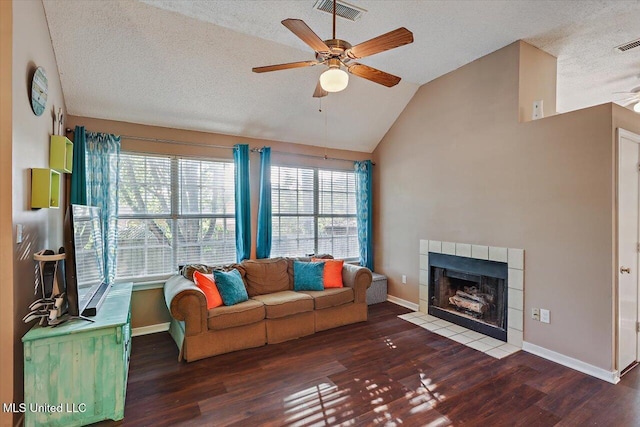 living area featuring ceiling fan, a textured ceiling, visible vents, wood finished floors, and lofted ceiling
