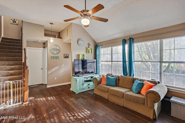 living area with ceiling fan, high vaulted ceiling, baseboards, wood finished floors, and stairway