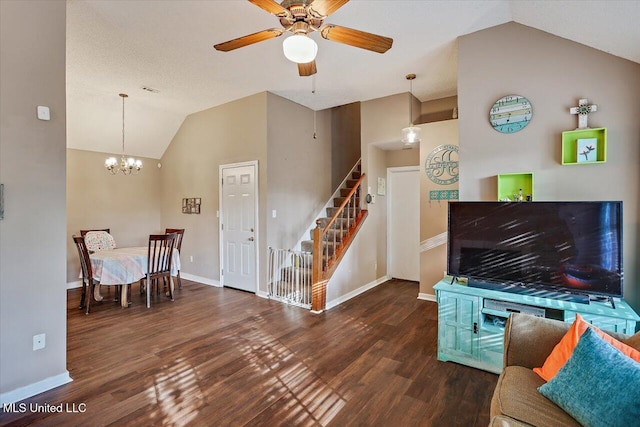 living area with ceiling fan with notable chandelier, baseboards, wood finished floors, lofted ceiling, and stairway
