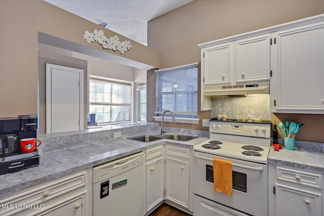 kitchen with a sink, white appliances, a textured ceiling, white cabinetry, and under cabinet range hood