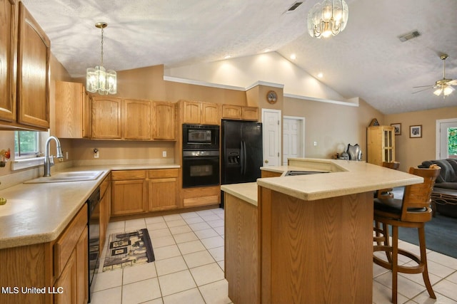 19639 Laterre Dr, Kiln, MS 39556 - kitchen with black appliances, lofted ceiling, a chandelier, light tile patterned floors, and light countertops