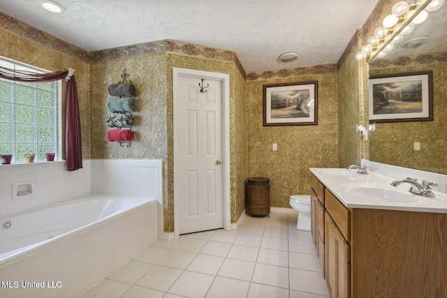 19639 Laterre Dr, Kiln, MS 39556 - full bathroom featuring wallpapered walls, a textured ceiling, double vanity, a bath, and tile patterned flooring