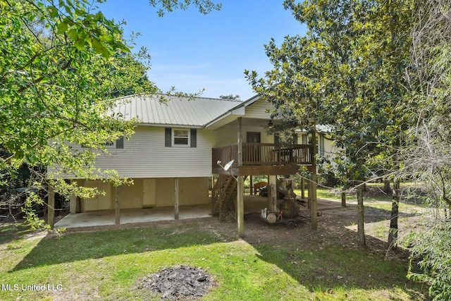 19639 Laterre Dr, Kiln, MS 39556 - rear view of property featuring a patio area, stairs, a lawn, a metal roof, and a wooden deck