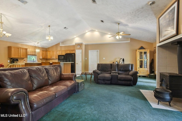 19639 Laterre Dr, Kiln, MS 39556 - carpeted living room featuring a wood stove, vaulted ceiling, a ceiling fan, a chandelier, and a textured ceiling