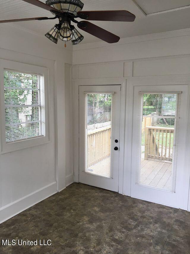 doorway to outside featuring plenty of natural light and ceiling fan