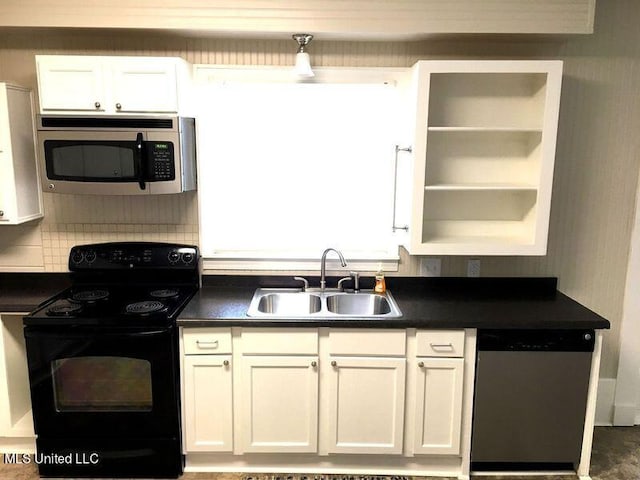 kitchen featuring appliances with stainless steel finishes, white cabinetry, sink, and backsplash