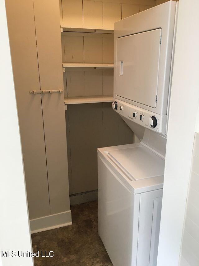 laundry area featuring stacked washer and dryer