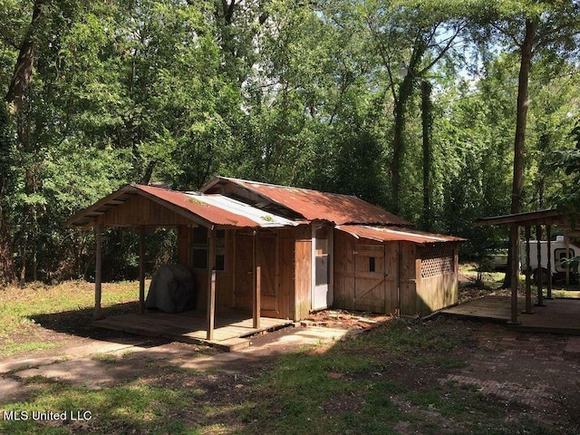 exterior space featuring a deck and an outbuilding