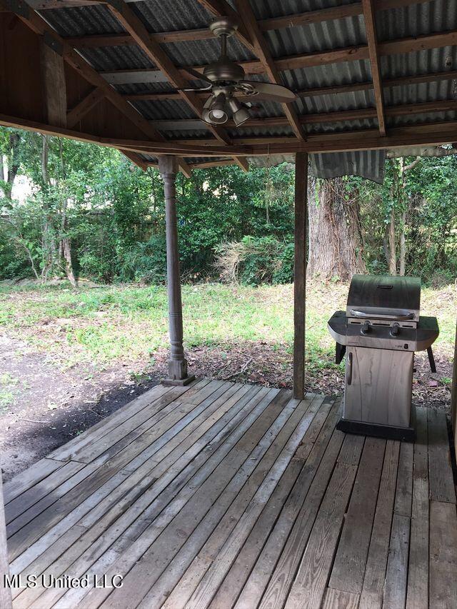 wooden deck with ceiling fan and grilling area