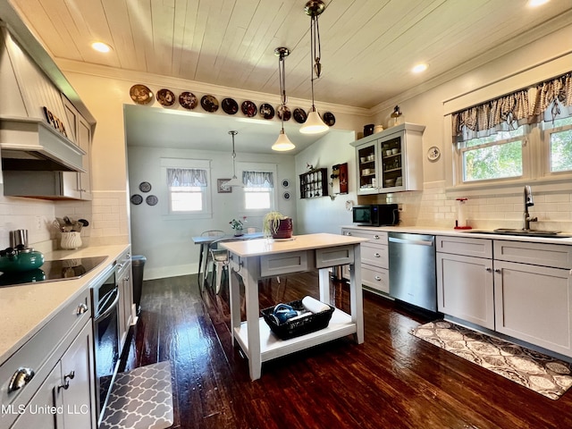 914 39th Ave, Gulfport, MS 39501 - kitchen featuring black appliances, a sink, dark wood-style flooring, pendant lighting, and glass insert cabinets