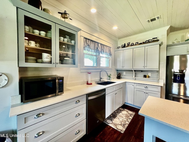 914 39th Ave, Gulfport, MS 39501 - kitchen featuring fridge with ice dispenser, stainless steel microwave, dishwashing machine, a sink, and glass insert cabinets