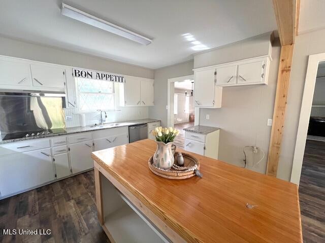 kitchen with sink, white cabinetry, black stovetop, stainless steel dishwasher, and dark wood-type flooring