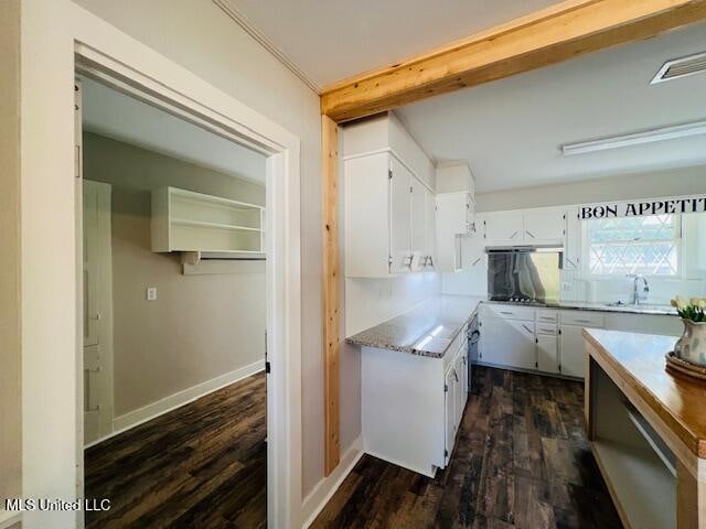 kitchen featuring sink, white cabinetry, and dark hardwood / wood-style flooring