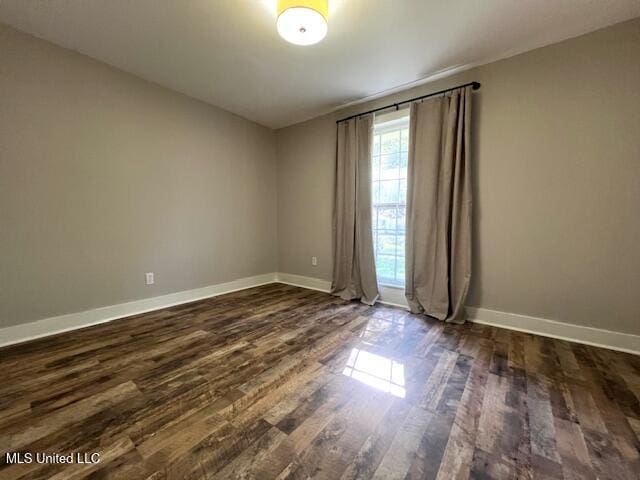 empty room with dark wood-type flooring