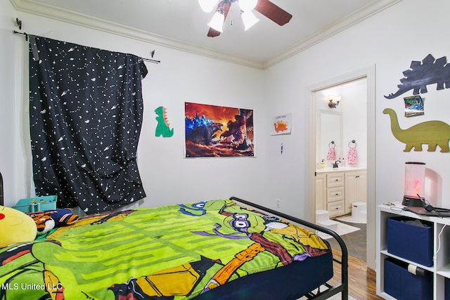 bedroom featuring crown molding, ensuite bath, hardwood / wood-style flooring, and ceiling fan