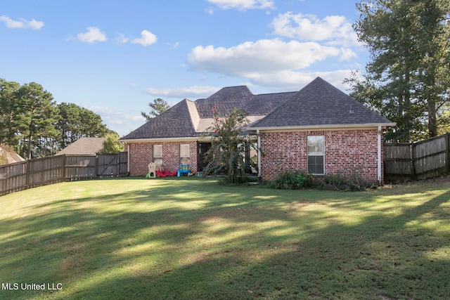 rear view of house with a yard