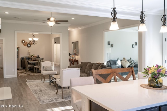 interior space featuring ceiling fan, ornamental molding, wood finished floors, and recessed lighting