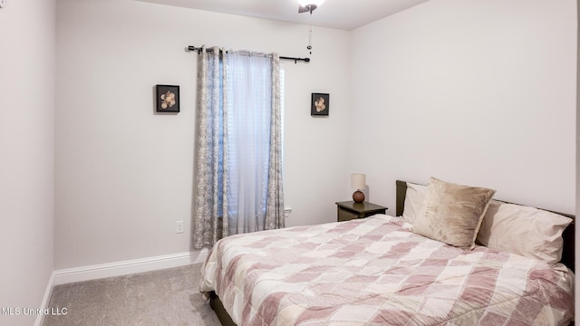 carpeted bedroom featuring baseboards