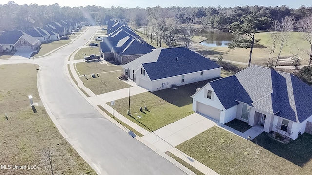 birds eye view of property with a water view