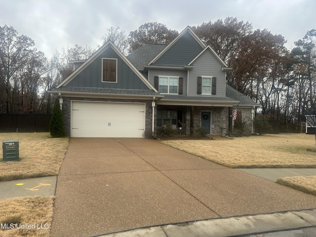 craftsman house featuring a front yard and a garage