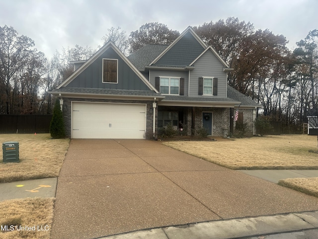 craftsman house featuring a front yard and a garage