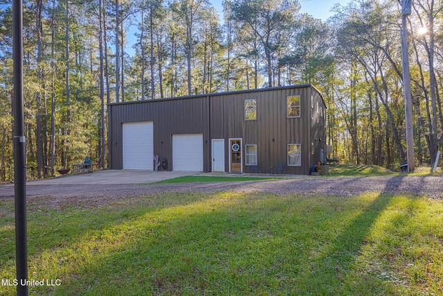 view of outdoor structure with a garage and a yard