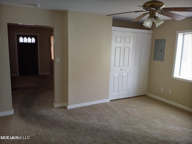 unfurnished bedroom featuring a closet, ceiling fan, electric panel, and carpet floors