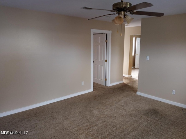 empty room featuring carpet floors and ceiling fan