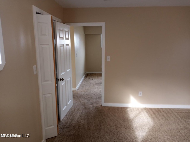 hallway featuring carpet flooring