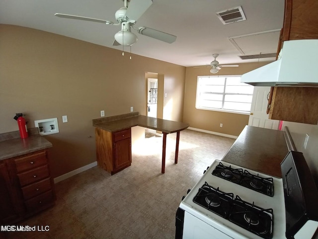 kitchen featuring ceiling fan, light colored carpet, range hood, and gas range gas stove