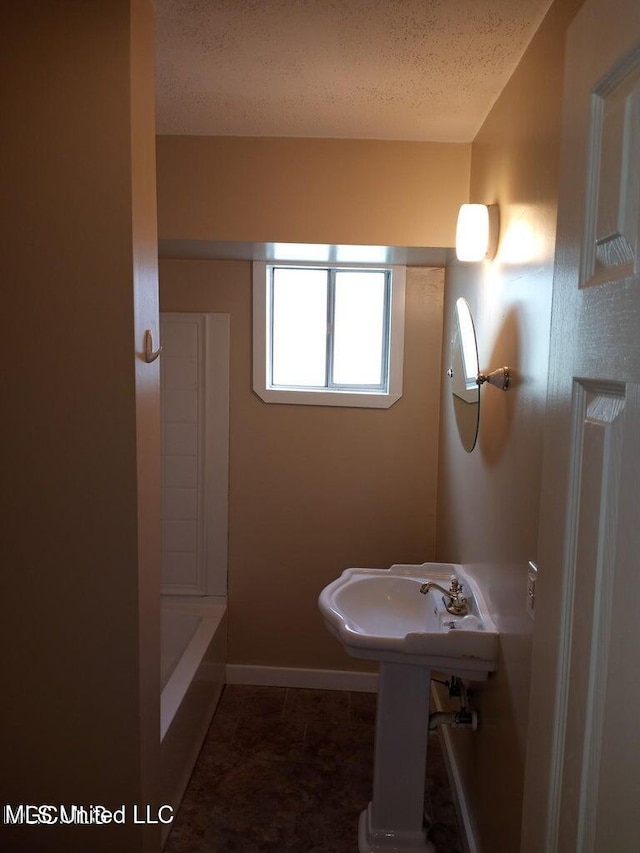 bathroom featuring a textured ceiling