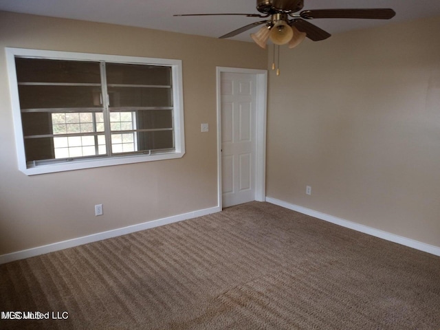 unfurnished room with ceiling fan and carpet floors