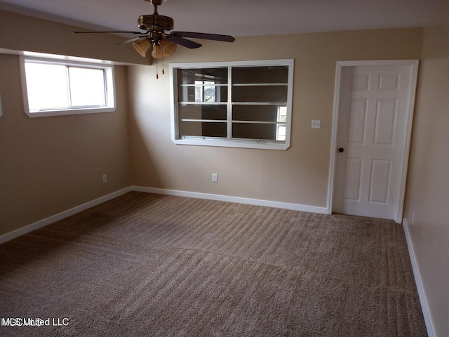 spare room with ceiling fan and carpet