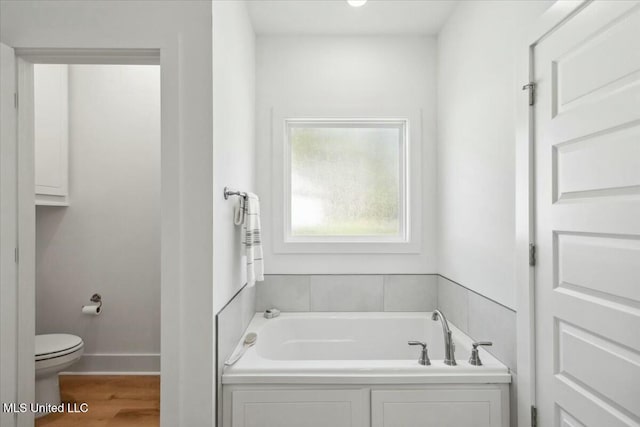 213 Dolly Ln, Magee, MS 39111 - full bath with a bath, toilet, baseboards, and wood finished floors