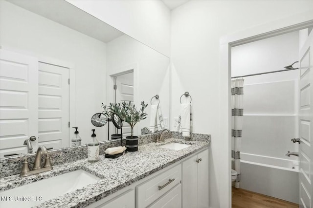 213 Dolly Ln, Magee, MS 39111 - bathroom featuring toilet, double vanity, shower / tub combo, and wood finished floors