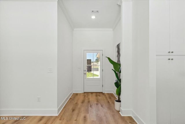 213 Dolly Ln, Magee, MS 39111 - doorway with ornamental molding, light wood-style flooring, and baseboards