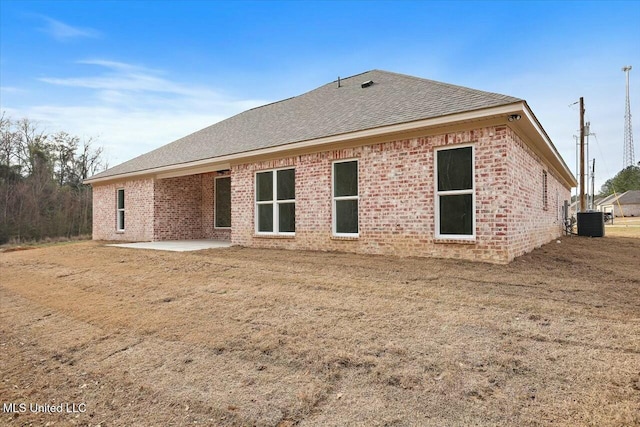 back of property with cooling unit and a patio area