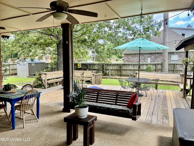 1024 Riverchase N Dr, Brandon, MS 39047 - fenced backyard featuring outdoor dining space, a storage shed, a ceiling fan, and a deck