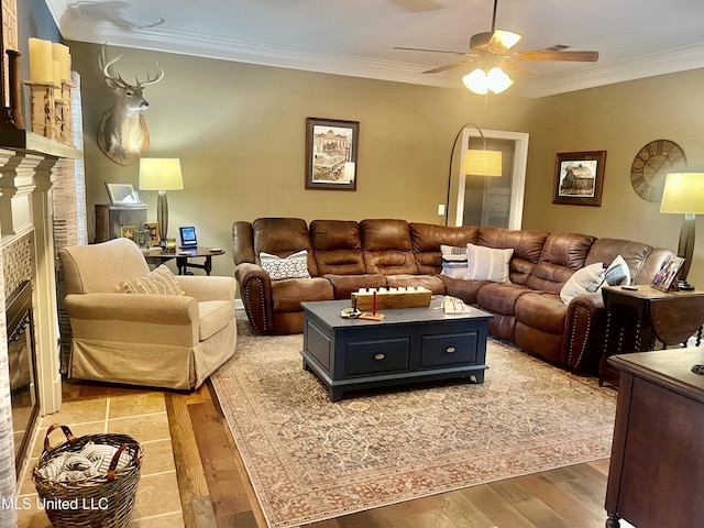1024 Riverchase N Dr, Brandon, MS 39047 - living area featuring a glass covered fireplace, ceiling fan, crown molding, and light wood-type flooring