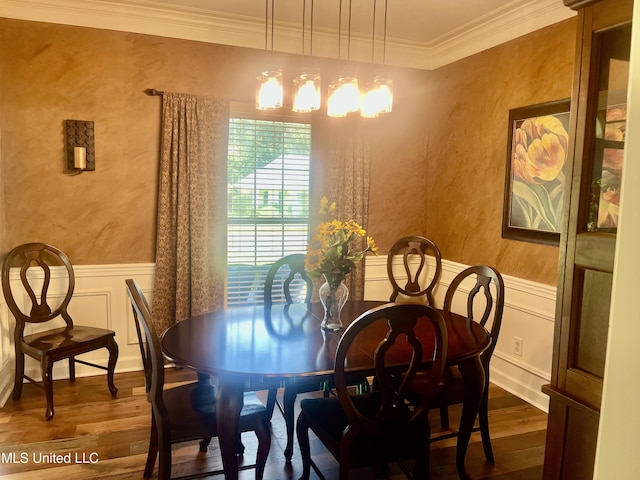 1024 Riverchase N Dr, Brandon, MS 39047 - dining space featuring dark wood finished floors, a chandelier, crown molding, wainscoting, and a decorative wall