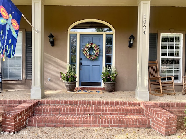 1024 Riverchase N Dr, Brandon, MS 39047 - view of exterior entry with a porch and stucco siding