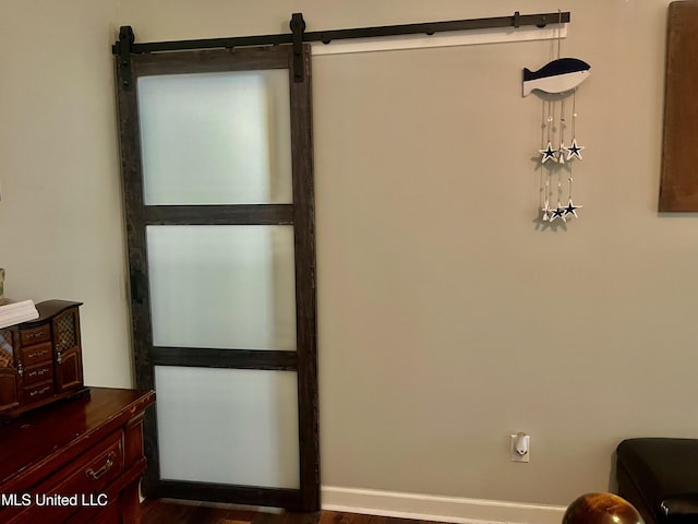 1024 Riverchase N Dr, Brandon, MS 39047 - living area featuring a barn door and dark wood-type flooring
