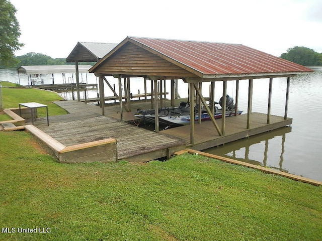 dock area with a yard and a water view