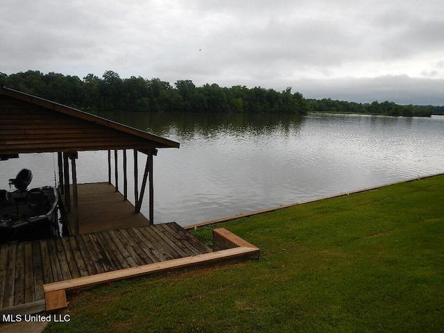 view of dock with a water view and a yard