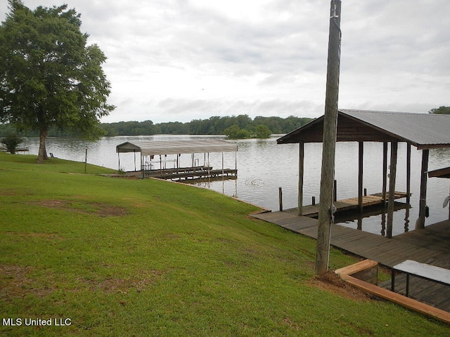 view of dock featuring a yard and a water view