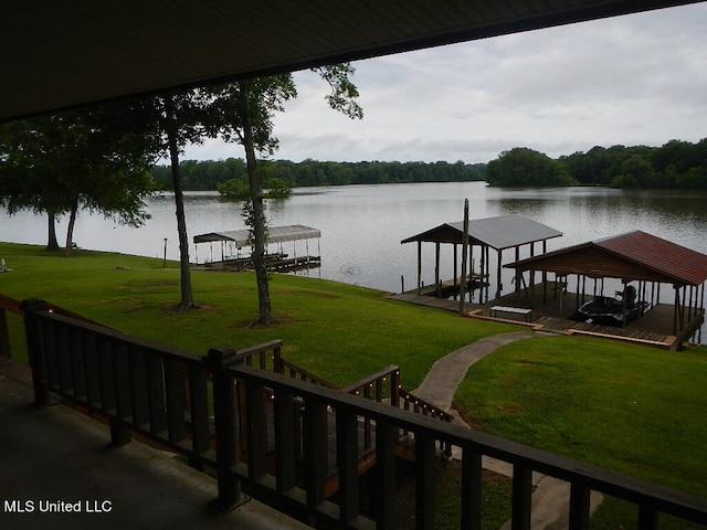 dock area featuring a water view and a yard